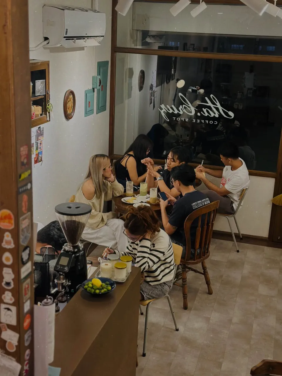 Friends sharing drinks and conversation inside Sta. Cruz Coffee Spot
