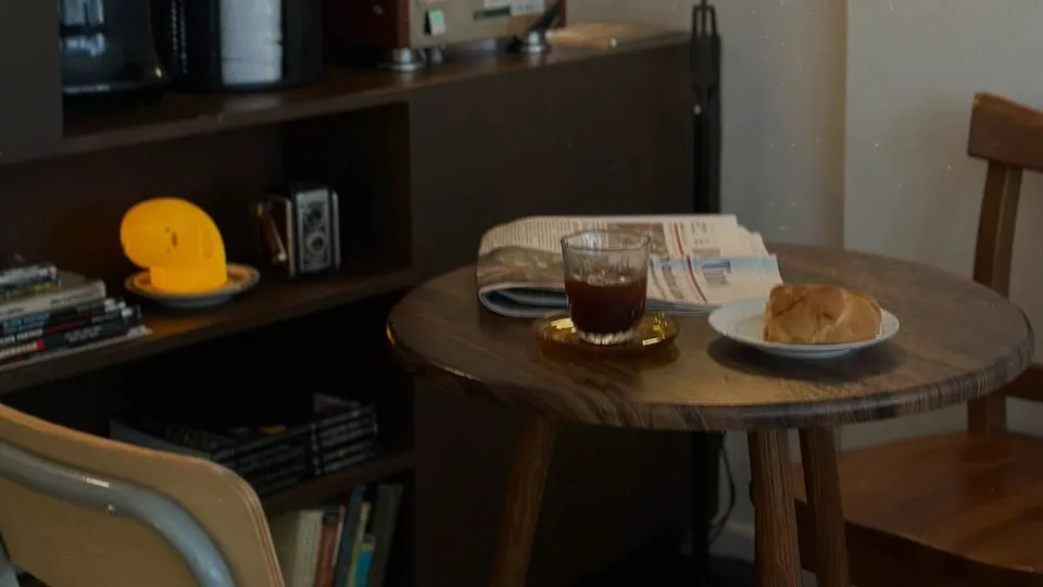 Coffee and bread on a cafe table at night