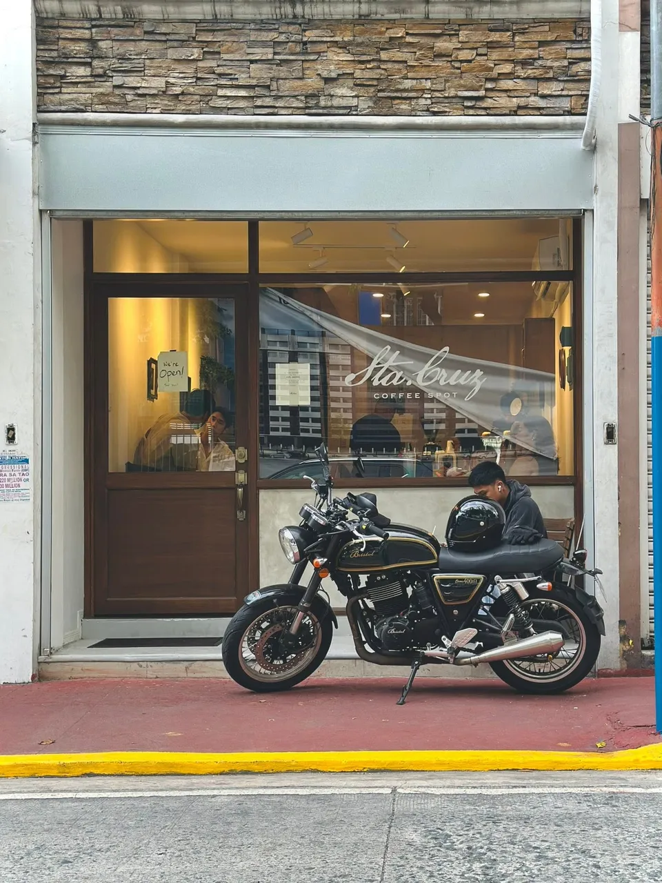Sta. Cruz Coffee Spot storefront with a motorcycle parked outside
